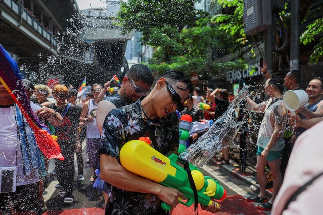 Revellers play with water during a gay parade as they celebrate the Songkran holiday which marks the Thai New Year in Bangkok, Thailand, on April 14, 2024. (Photo by Chalinee Thirasupa/Reuters)