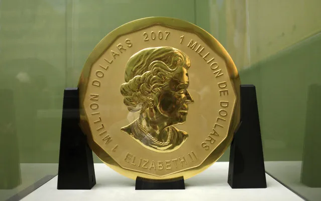 The December 12, 2010 file photo shows the gold coin “Big Maple Leaf” in the Bode Museum in Berlin. Thieves broke into the German capital's Bode Museum before dawn Monday and made off with a massive 100-kilogram (221-pound) gold coin worth millions of dollars, police said. Police spokesman Stefen Petersen said thieves apparently entered through a window about 3:30 a.m. Monday, broke into a cabinet where the “Big Maple Leaf” coin was kept, and escaped with it before police arrived. The three-centimeter (1.18-inch) thick coin, with a diameter of 53 centimeters (20.9 inches), has a face value of 1 million Canadian dollars ($750,000). By weight alone, however, it would be worth almost $4.5 million at market prices. (Photo by Marcel Mettelsiefen/DPA via AP Photo)