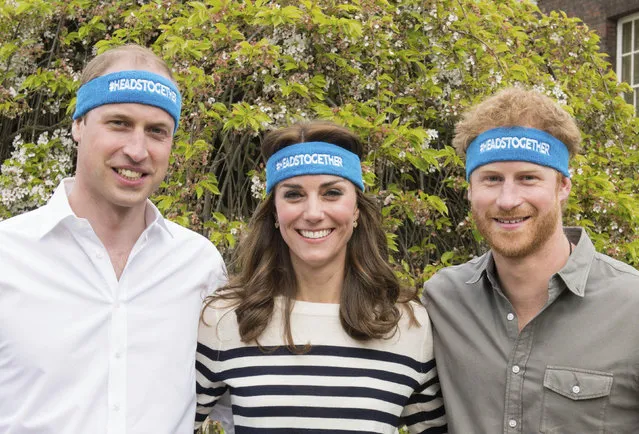 Undated handout  photo of Britain's  Prince William, left, Kate Duchess of Cambridge and Prince Harry wearing charity headbands  issued by The Royal Foundation of the Duke and Duchess of Cambridge and Price Harry. The three royals are spearheading a campaign to encourage people to talk openly about mental health issues. The young royals released 10 films Thursday as part of their Heads Together campaign to change the national conversation on mental health. (Photo by The Royal Foundation of the Duke and Duchess of Cambridge and Price Harry via AP Photo)