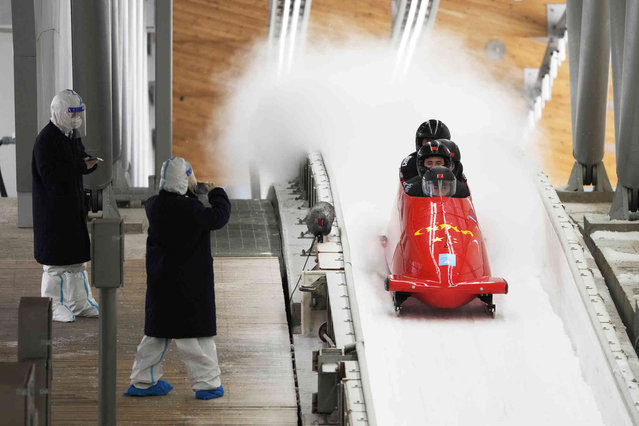 Sun Kaizhi of China and his team finish during a 4-man bobsleigh training heat at the 2022 Winter Olympics, Thursday, February 17, 2022, in the Yanqing district of Beijing. (Photo by Dmitri Lovetsky/AP Photo)