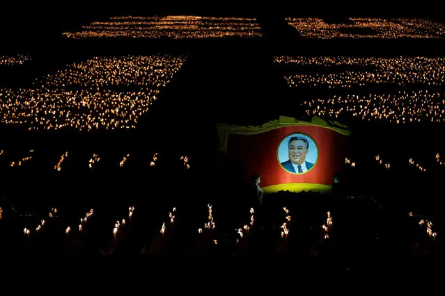 Participants carry torches and a picture of former North Korean leader Kim Il Sung during a torchlight procession in the capital's main ceremonial square, a day after the ruling Workers' Party of Korea party wrapped up its first congress in 36 years, in Pyongyang, North Korea, May 10, 2016. (Photo by Damir Sagolj/Reuters)