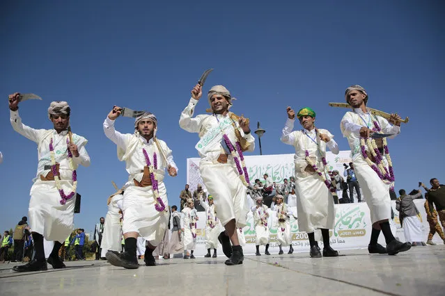 Yemeni grooms dressed in traditional attires dance during a traditional mass wedding, held by the Houthis for thousands of couples in Sanaa, Yemen, Thursday, December 02, 2021. (Photo by Hani Mohammed/AP Photo)