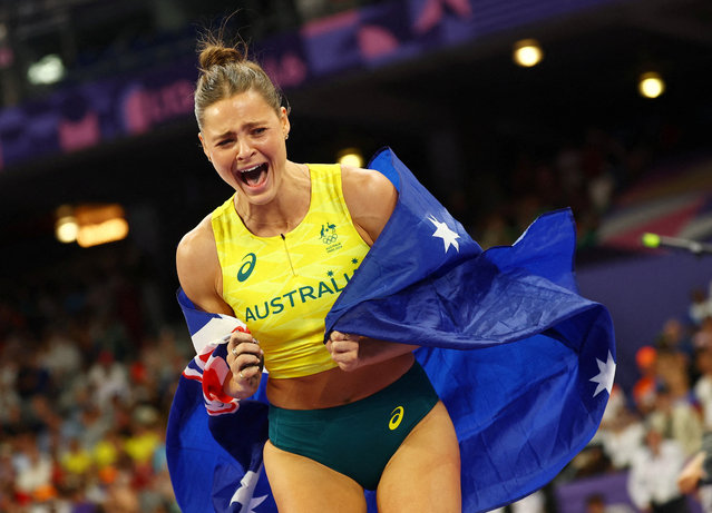 Nina Kennedy of Australia celebrates her gold medal win in the Women's Pole Vault Final during the Athletics Competition at the Stade de France during the Paris 2024 Summer Olympic Games on August 7th, 2024, in Paris, France. (Photo by Kai Pfaffenbach/Reuters)