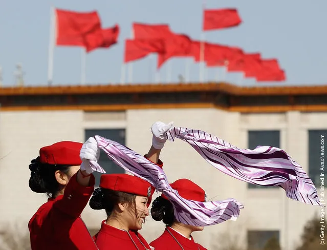 Hostesses pose for photos in windy during the third plenary meeting of the 11th National Committee of the Chinese People's Political Consultative Conference (CPPCC) at The Great Hall Of The People