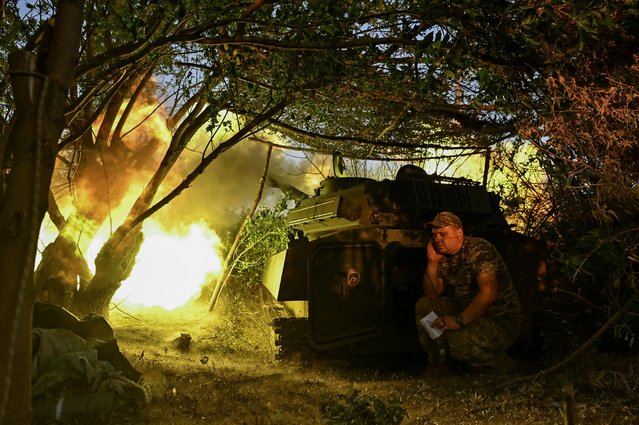 An artillerist of the 24th Mechanized Brigade of the Ukrainian Armed Forces, named after King Danylo, fires a 2S1 Gvozdika self-propelled howitzer towards Russian troops, amid Russia’s attack on Ukraine, near the town of Chasiv Yar in Donetsk region, Ukraine on July 14, 2024. (Photo by Reuters/Stringer)