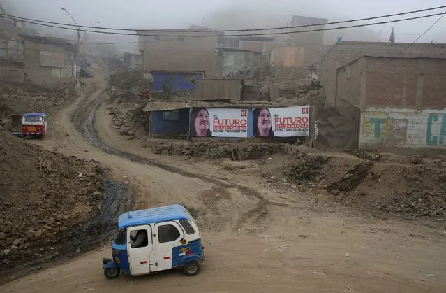 Signs promoting presidential candidate Keiko Fujimori hang in the Villa el Salvador shantytown, where a moto-taxi drives by in Lima, Peru, Saturday, June 4, 2016. The South American country is gearing up for a tight June 5th runoff between Keiko Fujimori, the daughter of jailed former President Alberto Fujimori, and former World Bank economist Pedro Kuczynski. (Photo by Martin Mejia/AP Photo)