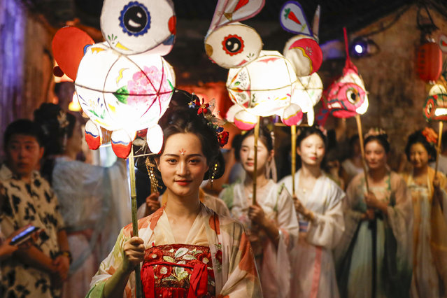 People holding rabbit-shaped lanterns parade at Hongcun Village to welcome the Mid-Autumn Festival on September 15, 2024 in Huangshan City, Anhui Province of China. This year's Mid-Autumn Festival falls on September 17. (Photo by Shi Yalei/VCG via Getty Images)