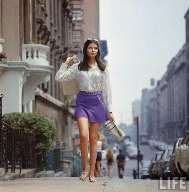 Woman (possibly model), with long hair wearing short skirt, lace top & sandals, walking up street in New York, 1969. (Photo by Vernon Merritt III/Time & Life Pictures/Getty Image)