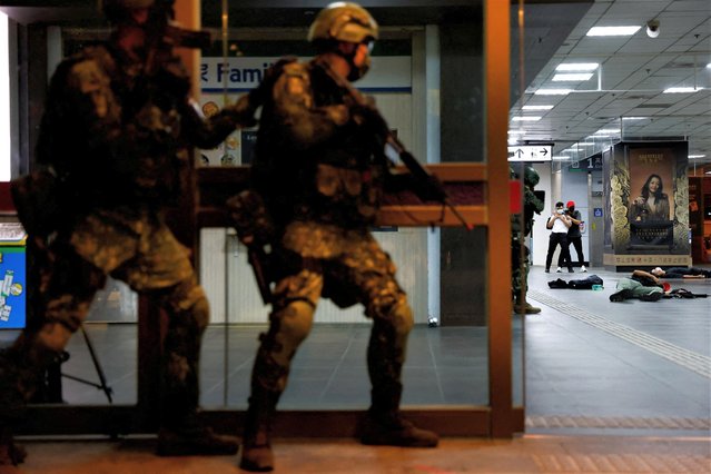 Soldiers conduct drills at Taipei main station for the first time during the annual military drill in Taipei, Taiwan on July 26, 2023. (Photo by Ann Wang/Reuters)