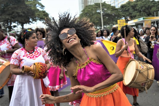 A woman dances during the Black Women's March against racism, violence and oppression, at Copacabana beach in Rio de Janeiro, Brazil, Sunday, July 30, 2023. (Photo by Bruna Prado/AP Photo)