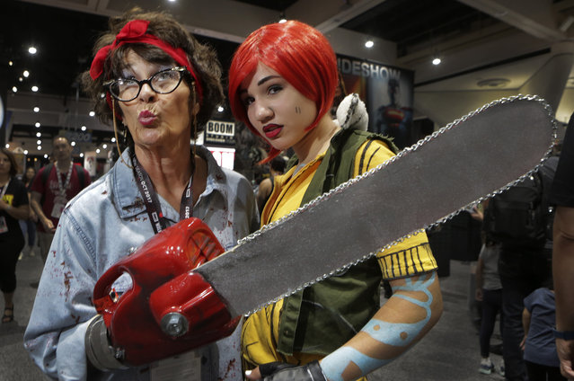 Anne Leanzo, of Virginia, plays Ash from the Evil Dead movie and her daughter Gina, 15, plays Lilith from the Borderlands video game during Comic-Con 2017 in San Diego, California, July 22, 2017. (Photo by Bill Wechter/AFP Photo)