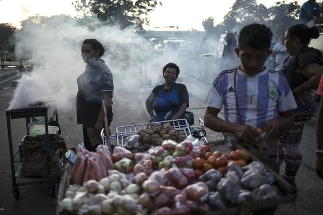 In this November 15, 2019 photo, street vendors wait for customers in “Las Pulgas” market in Maracaibo, Venezuela. In Maracaibo, located in Venezuela’s western Zulia state along the Colombian border, many residents say they’ve abandoned political marches, lacking faith in leaders or fearing for their personal safety. (Photo by Rodrigo Abd/AP Photo)