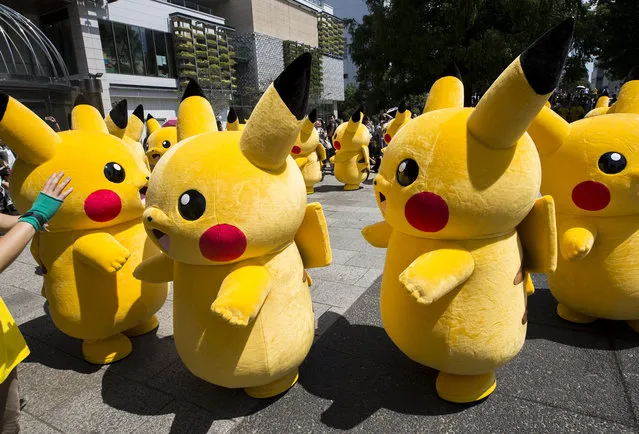 Performers dressed as Pikachu, a character from Pokemon series game titles, march during the Pikachu Outbreak event hosted by The Pokemon Co. on August 9, 2017 in Yokohama, Kanagawa, Japan. (Photo by Tomohiro Ohsumi/Getty Images)