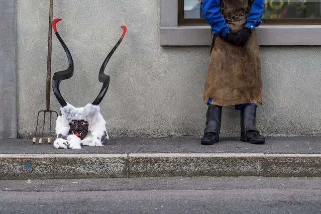 A devil is waiting for the move at the traditional Suehudi parade during the carnival season in Einsiedeln, Switzerland, 24 February 2020. (Photo by Urs Flueeler/Keystone)
