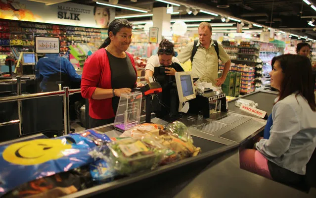 Premier Aleqa Hammond, the leader of Greenlands Parliament (L) shops for food in the grocery store on July 29, 2013 in Nuuk, Greenland. (Photo by Joe Raedle/Getty Images)