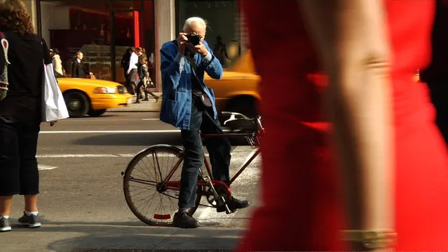 Bill Cunningham shooting on the street in New York City from the feature-length documentary, “Bill Cunningham New York”, ( 2010),  directed by Richard Press and produced by Philip Gefter. (Photo by First Thought Films)