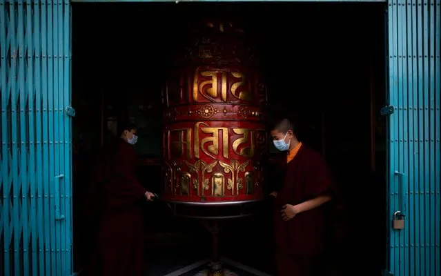 People wearing protective masks spin a prayer wheel during a mass prayer for the victims of coronavirus, at Boudhha stupa, also known as Boudhanath, in Kathmandu, Nepal, 15 February 2020. The event was organized by the famous Chokyi Nyima Rinpoche of Ka-Nying Monastery. Nepal has so far reported only one case of infection. The disease caused by the novel coronavirus (SARS-CoV-2) has been officially named COVID-19 by the World Health Organization (WHO). The outbreak, which originated in the Chinese city of Wuhan, has so far killed at least 1,526 people with over 67,000 infected worldwide, mostly in China. (Photo by Narendra Shrestha/EPA/EFE/Rex Features/Shutterstock)