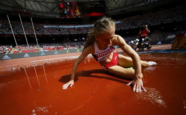 Sviatlana Kudzelich of Belarus falls in the women's 3,000 metres steeplechase heat during the 15th IAAF World Championships at the National Stadium in Beijing, China August 24, 2015. (Photo by Kai Pfaffenbach/Reuters)