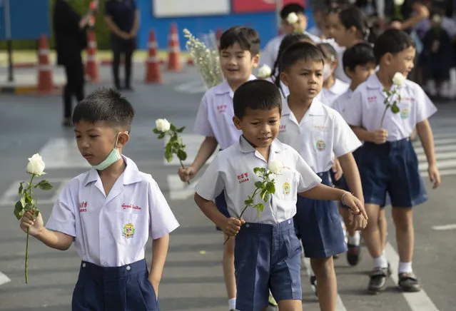 Assumption kindergarten's children prepare to offer flowers at the scene of a deadly mass shooting outside the Terminal 21 shopping mall in Korat, Nakhon Ratchasima, Thailand Tuesday, February 11, 2020. A soldier carried out the country's worst mass shooting in an hourslong siege at the shopping mall. (Photo by Sakchai Lalit/AP Photo)
