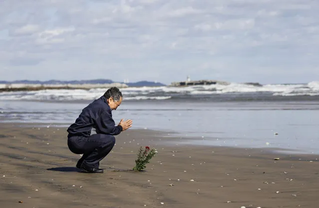 A man prays toward the sea to mourn victims of the March 11, 2011 earthquake and tsunami disaster in Iwaki, Fukushima prefecture, Japan, in this photo taken by Kyodo March 11, 2020, to mark the nine-year anniversary of the disaster. (Photo by Kyodo News via Reuters)