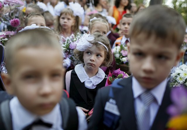 First graders attend a ceremony to mark the start of another school year in Kiev, Ukraine, September 1, 2015. (Photo by Gleb Garanich/Reuters)