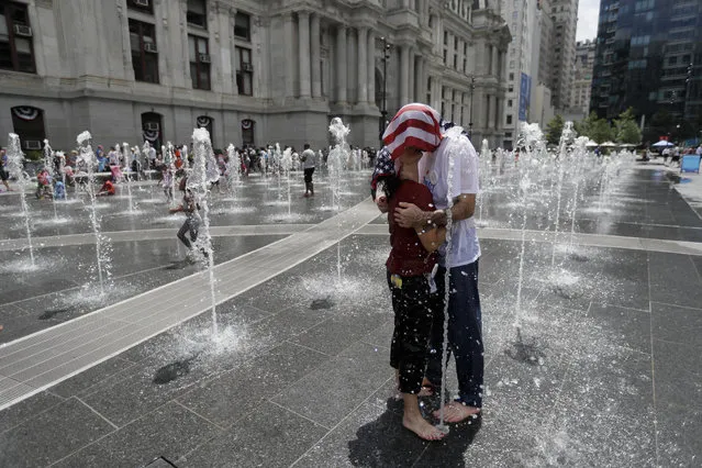 Two supporters of Sen. Bernie Sanders, I-Vt., cool off in a fountain at City Hall during a rally in Philadelphia, Tuesday, July 26, 2016, during the second day of the Democratic National Convention. (Photo by Matt Slocum/AP Photo)