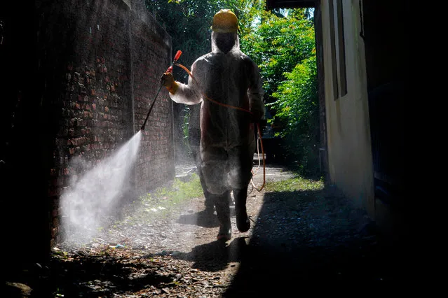 An Indonesian soldier sprays disinfectant in the compounds of a boarding house, which housed foreign students from Malaysia, amid the COVID-19 coronavirus pandemic in Banda Aceh on April 20, 2020. (Photo by Chaideer Mahyuddin/AFP Photo)