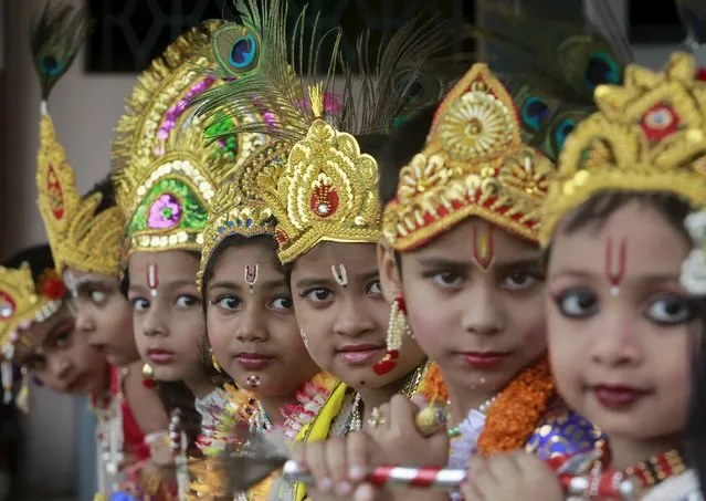 Schoolchildren dressed as Hindu Lord Krishna, wait to perform during the celebrations to mark the Janmashtami festival in Agartala, India, September 5, 2015. The festival, which marks the birth anniversary of Lord Krishna, is being celebrated across the country today. (Photo by Jayanta Dey/Reuters)