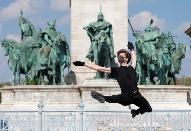 Hungarian ballet dancer Zsolt Kovacs performs a choreographic piece he has designed for the “coronavirus melody”, a musical composition created by MIT scientists from a model of the protein structure of SARS-CoV-2, during the coronavirus disease (COVID-19) outbreak in Budapest, Hungary, April 28, 2020. (Photo by Bernadett Szabo/Reuters)