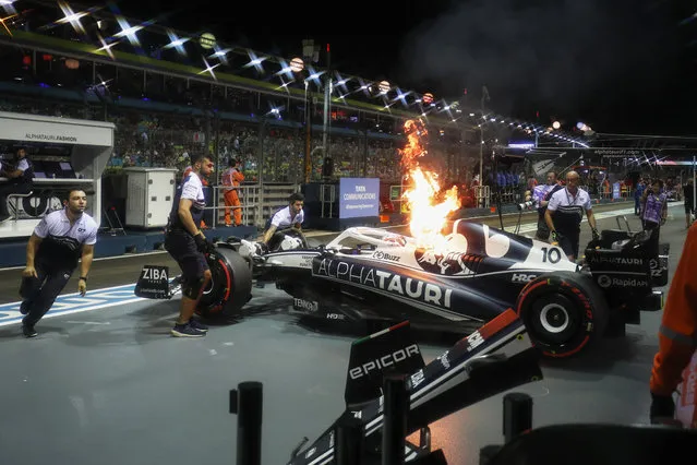 Pierre Gasly's car catches fire at the Formula One Singapore Grand Prix at Marina Bay Circuit on September 30, 2022, in Marina Bay, Singapore. (Photo by Zak Mauger/Motorsport Images/Splash News and Pictures)