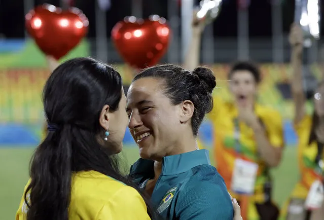 Brazil's Isadora Cerullo, right, shares a moment with her partner Marjorie Enya, after she was asked her to marry her, after the medal ceremony for the women's rugby sevens match at the Summer Olympics in Rio de Janeiro, Brazil, Monday, August 8, 2016. (Photo by Themba Hadebe/AP Photo)