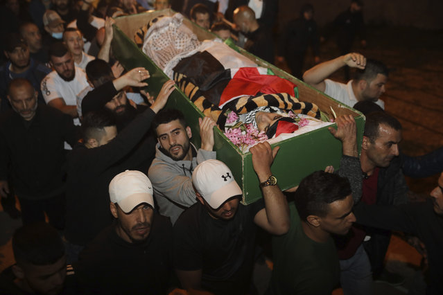 Muslim men carry the body of Iyad Halak to burial after Israeli police shot him dead in Jerusalem's old city, Sunday, May 31, 2020. Israel's defense minister has apologized for the Israeli police's deadly shooting of an unarmed Palestinian man who was autistic. (Photo by Mahmoud Illean/AP Photo)