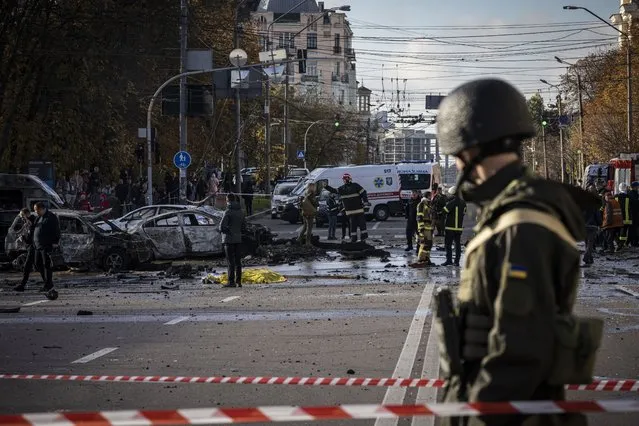 Emergency service personnel attend to the site of a blast on October 10, 2022 in Kyiv, Ukraine. This morning's explosions, which came shortly after 8:00 local time, were the largest such attacks in the capital in months. (Photo by Ed Ram/Getty Images)
