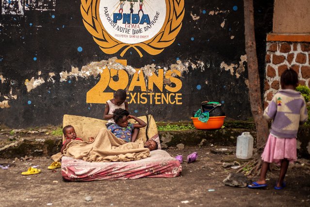 Displaced children who sought refuge at the church following clashes rest in the courtyard of the Notre Dame d'Afrique Church in Goma on February 2, 2025. The conflict in eastern Democratic Republic of Congo risks escalating into a broader regional war, Burundi's president said on February 1, 2025, as Africa's top health agency warned the fighting could spark new outbreaks of serious diseases The Rwanda-backed armed group M23 has vowed to march on the capital Kinshasa after capturing eastern DRC's biggest city of Goma. (Photo by Jospin Mwisha/AFP Photo)