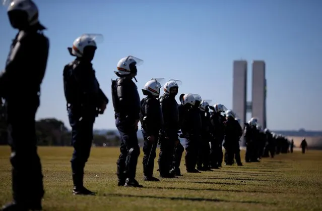 Police officers stand guard during a demonstration against Brazilian President Jair Bolsonaro, racism and in support of democracy in Brasilia, Brazil on June 7, 2020. (Photo by Adriano Machado/Reuters)