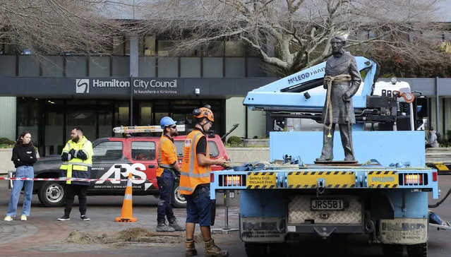 In this image provided by Hamilton City Council, council workers remove the bronze statue of British Captain John Fane Charles Hamilton from a square in central Hamilton, New Zealand, Friday, June 12, 2020. The New Zealand city of Hamilton on Friday removed a bronze statue of the British naval officer the city is named after a man who is accused of killing indigenous Maori people in the 1860s. (Photo by Hamilton City Council via AP Photo)