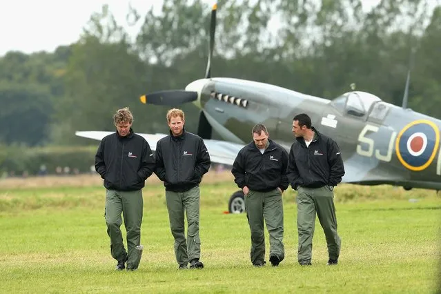 Prince Harry walks on the airfield at Goodwood Aerodrome as he is shown Spitfire Aircraft that will take place in a Battle of Britain Flypast at Goodwood on September 15, 2015 in Chichester, England.  The 75th Anniversary of the Battle of Britain is being marked by a historic flypast that brings more Battle of Britain aircraft together than ever before as a show of thanks to “the few” and the sacrifices they made. (Photo by Chris Jackson/Getty Images)