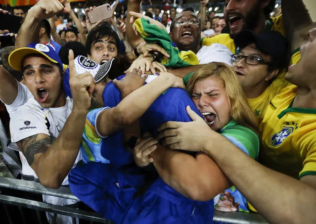 Brazil's Rafaela Silva, center, celebrates with supporters after winning the gold medal of the women's 57-kg judo competition at the 2016 Summer Olympics in Rio de Janeiro, Brazil, Monday, August 8, 2016. (Photo by Markus Schreiber/AP Photo)