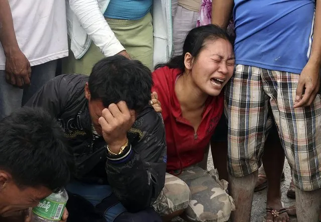 Relatives grieve as they view bodies recovered from floods in New Bataan, Compostela Valley province, southern Philippines Wednesday, Dec. 5, 2012. The death toll from Typhoon Bhopa climbed to more than 100 people Wednesday, while scores of others remain missing in the worst-hit areas of the southern Philippines. (Photo by Karlos Manlupig/AP Photo)