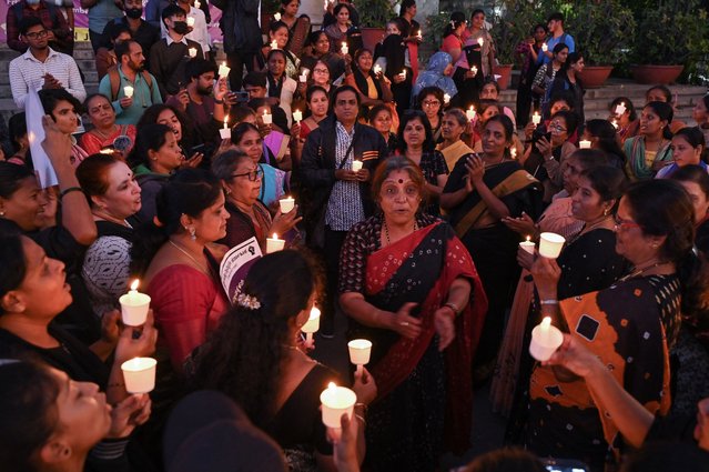 Activists light candles during a demonstration by pro womens' rights organisations on the occasion of “International Day for the Elimination of Violence Against Women”, in Bengaluru on November 25, 2022. (Photo by Manjunath Kiran/AFP Photo)