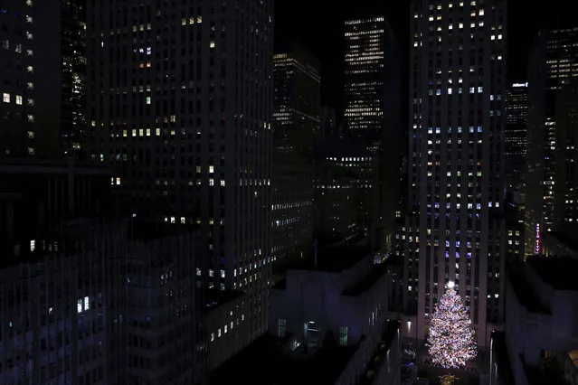 The Rockefeller Center Christmas tree stands illuminated following the 90th annual lighting ceremony, Wednesday, November 30, 2022, in New York. (Photo by Julia Nikhinson/AP Photo)