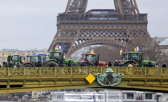 Farmers and their tractors from the rural coordination agricultural union demonstrate on the Pont Mirabeau with the Eiffel Tower in the background before the opening of the 60th International Agricultural Show on February 23, 2024 in Paris, France. On the eve of the opening of the Agricultural Show, farmers, still not convinced by the government's promises and actions, are demonstrating in Paris. Two tractor parades are planned this Friday in Paris and the FNSEA union is refusing to participate in a debate organized with the French President, Emmanuel Macron this Saturday at the agricultural show. (Photo by Chesnot/Getty Images)