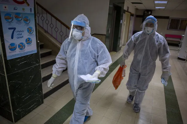 Palestinian medics wear protective suits as they take part in a simulation of possible coronavirus infections in Gaza City, Saturday, July 18, 2020. (Photo by Khalil Hamra/AP Photo)