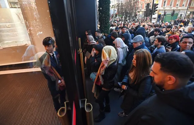 Shoppers queue up outside Selfridges retail store on Oxford Street in London, Britain, 26 December 2022. UK retailers are expecting a fall in retail sales due to the cost of living crisis that is impacting millions of households across Britain. (Photo by Andy Rain/EPA/EFE)