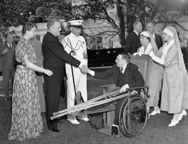 In this May 21, 1936 file photo, President Franklin D. Roosevelt and first lady Eleanor Roosevelt greet D.G. Durham, sitting in a wheelchair, during the annual garden party for disabled veterans at the White House in Washington. At center left is the president's military aide, Col. E.M. Watson. (Photo by AP Photo)