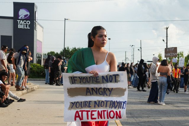 A demonstrator holds a sign during a protest against federal immigration sweeps, in Atlanta, Georgia, on June 10, 2025. (Photo by Megan Varner/Reuters)