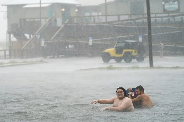 People play in a flooded parking lot at Navarre Beach, Tuesday, September 15, 2020, in Pensacola Beach, Fla. Hurricane Sally is crawling toward the northern Gulf Coast at just 2 mph, a pace that's enabling the storm to gather huge amounts of water to eventually dump on land. (Photo by Gerald Herbert/AP Photo)