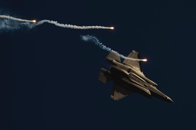 A fighter jet with the Royal Australian Air Force releases flares during an air show in Avalon, Australia, on Tuesday, March 25, 2025. (Photo by Asanka Ratnayake/Getty Images)