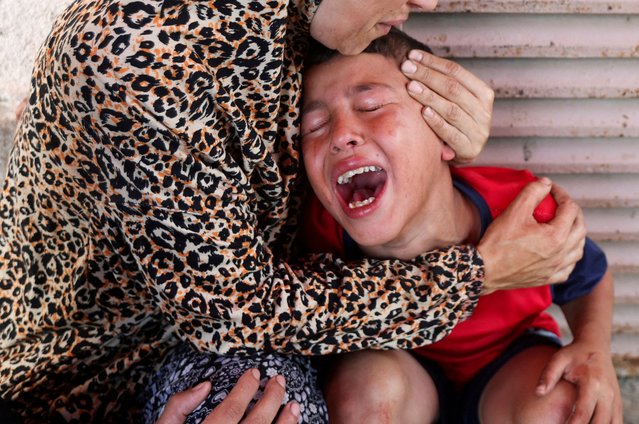 Palestinian mother Samah Al-Nouri, whose daughter Sama was killed in an Israeli strike on Thursday near a medical center in Deir Al-Balah, comforts her son, as casualties from the strike are brought into Al-Aqsa Martyrs Hospital, in Deir al-Balah, central Gaza Strip, on July 10, 2025. (Photo by Ramadan Abed/Reuters)