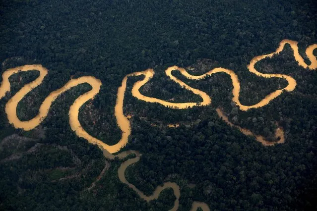 Aerial view of the Mucajai river, at the Yanomami Indigenous Territory, state of Roraima, Brazil, on January 28, 2023. Cases of malnutrition and malaria in the region have skyrocketed in recent weeks, prompting the new leftist government of President Lula Inacio Lula da Silva to declare a health emergency. (Photo by Michael Dantas/AFP Photo)